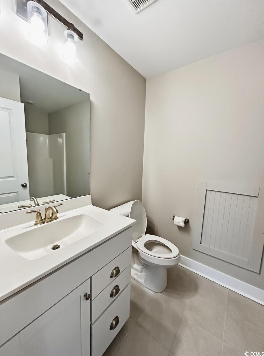 2108 Ballast Court Myrtle Beach, SC 29579 - Photo 27 of 37 Bathroom with vanity, a shower, and light tile patterned floors