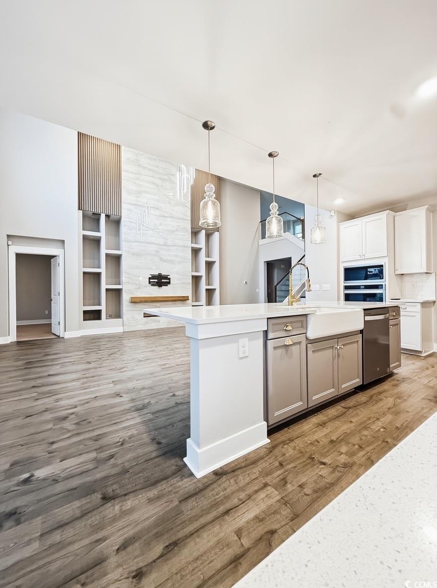 2108 Ballast Court Myrtle Beach, SC 29579 - Photo 37 of 37 Kitchen with open floor plan, hanging light fixtures, an island with sink, and light wood finished floors