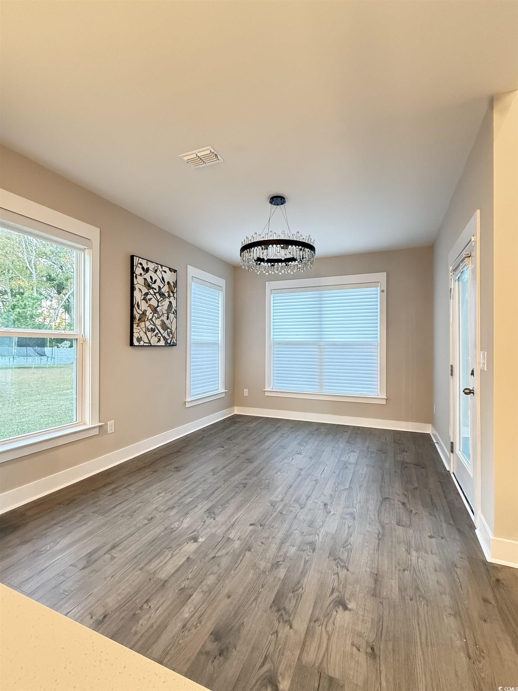 2108 Ballast Court Myrtle Beach, SC 29579 - Photo 6 of 37 dining area with wood finished floors and a chandelier