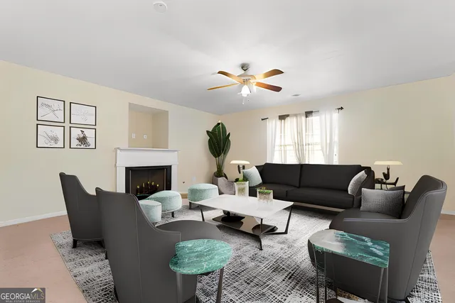 a living room with furniture a fireplace and a window