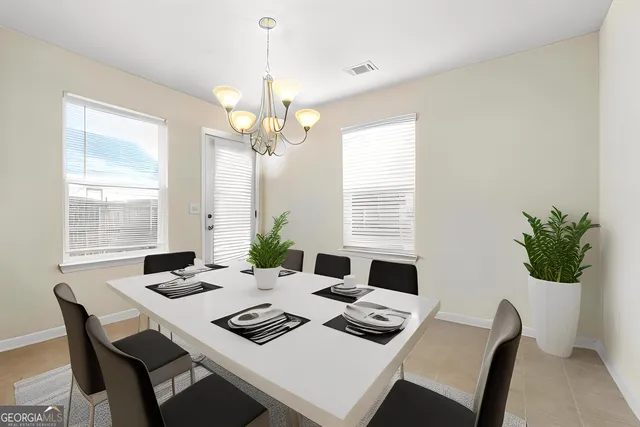 a view of a dining room with a table and chairs
