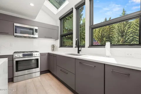 a kitchen with a sink and a microwave