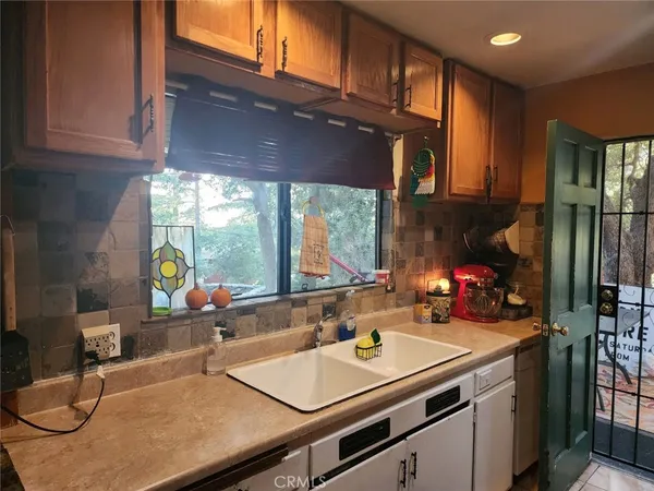 a kitchen with stainless steel appliances a sink a stove and a refrigerator