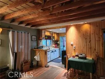 a view of a kitchen with fridge and outdoor seating