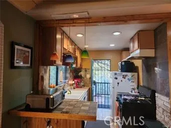 a kitchen with stainless steel appliances granite countertop a stove and a refrigerator