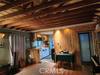 a room with stainless steel appliances kitchen island granite countertop furniture and a view of kitchen