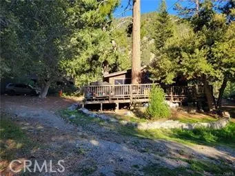 a view of a house with yard and sitting area