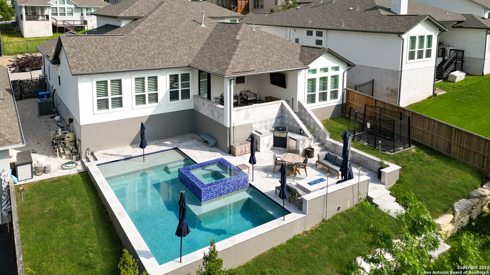a aerial view of a house with swimming pool and porch
