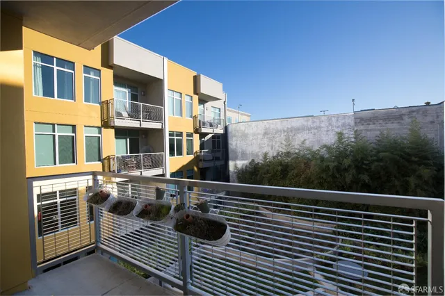 a view of a backyard with plants and outdoor seating