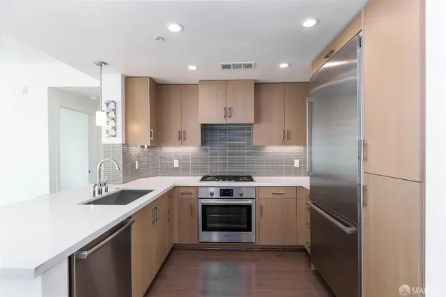 a kitchen with a stove sink and refrigerator