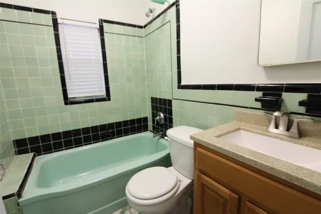 a bathroom with a sink a toilet and bathtub