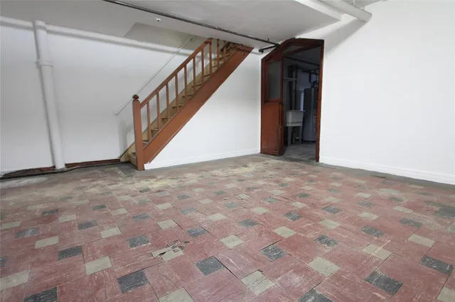 a view of an empty room with stairs