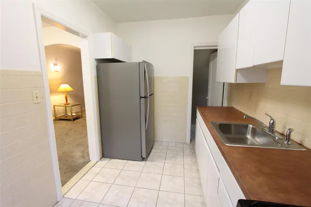 a kitchen with a refrigerator and cabinets