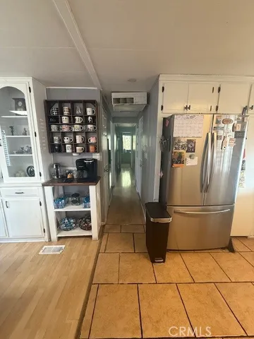 a kitchen with a refrigerator and cabinets