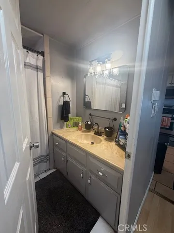 a bathroom with a double vanity sink mirror and shower