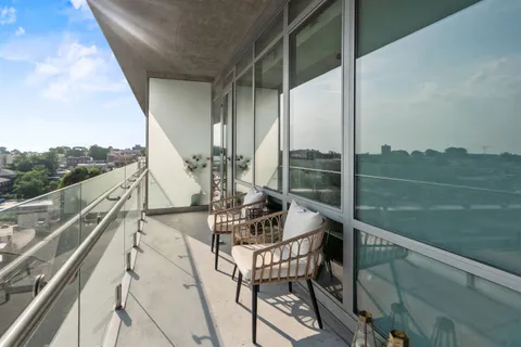 a view of a balcony with sitting area