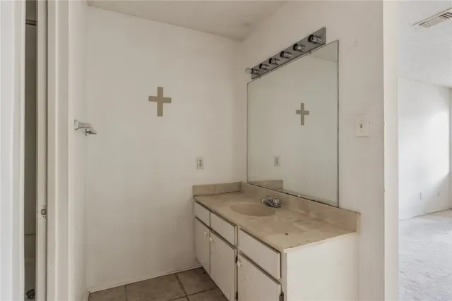 a bathroom with a granite countertop sink and shower