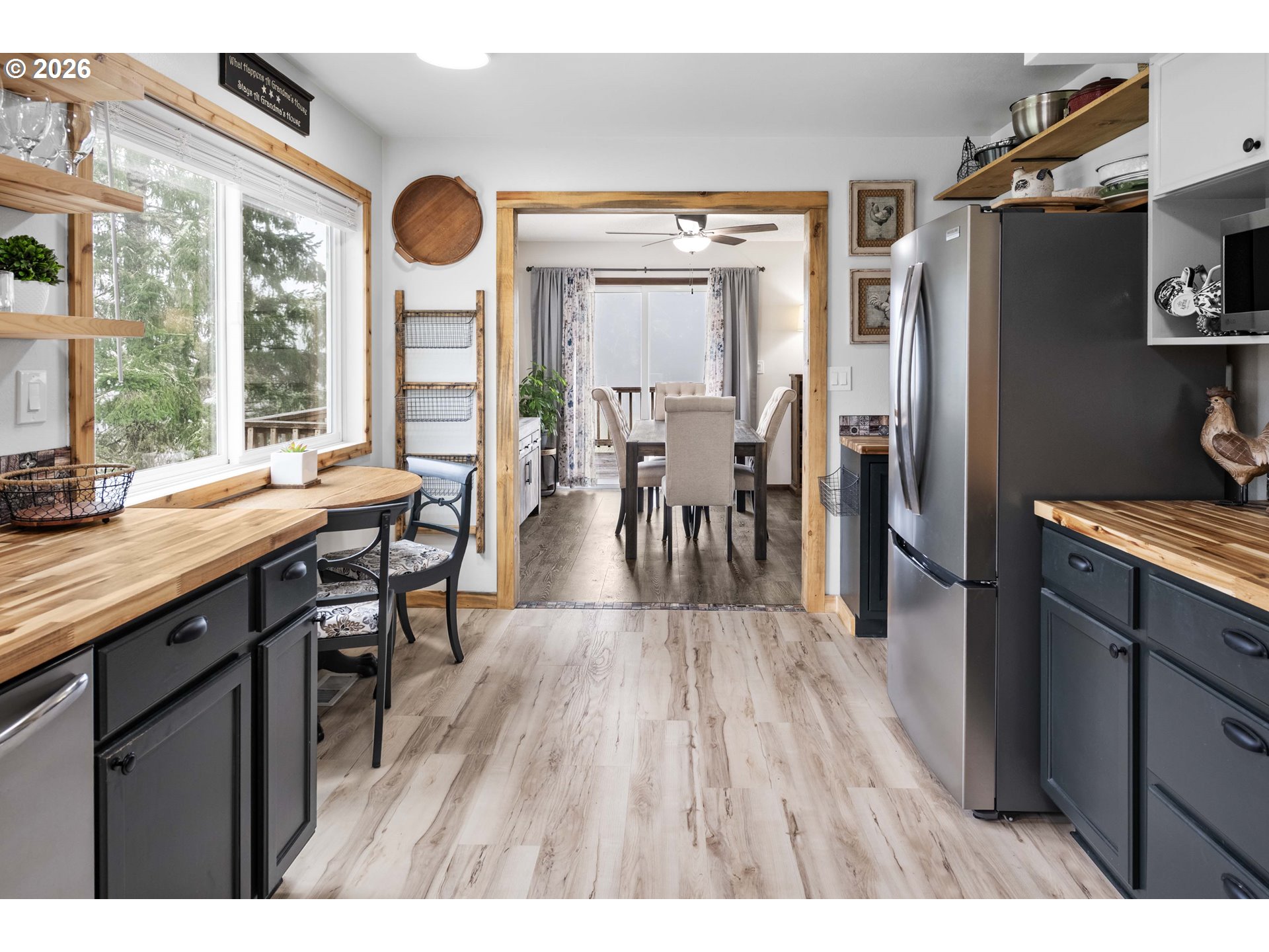 91614 George Hill Road Astoria, OR 97103 - Photo 12 of 44 a open kitchen with stainless steel appliances granite countertop a refrigerator a stove a sink a dining table and chairs with wooden floor