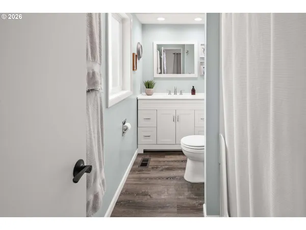 a bathroom with a sink a toilet and a mirror