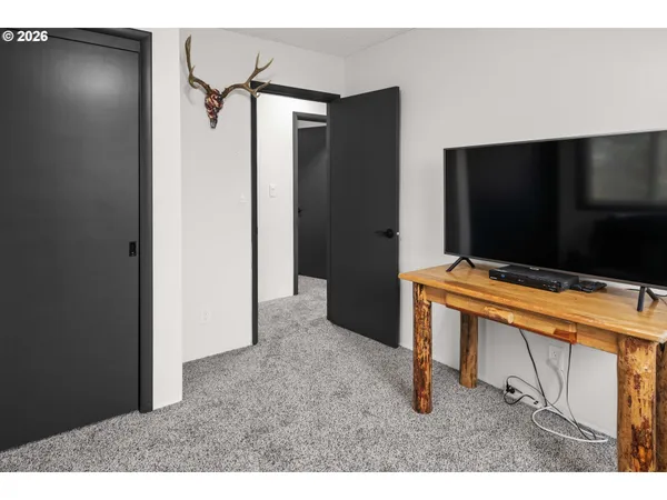 a living room with flat screen tv and furniture