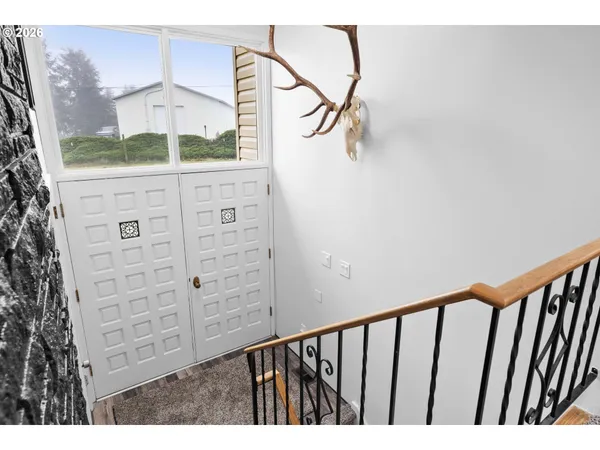 a view of a hallway with stairs