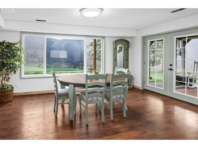 a dining room with furniture window and wooden floor