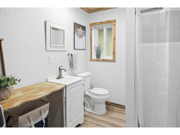 a bathroom with a sink a toilet and mirror