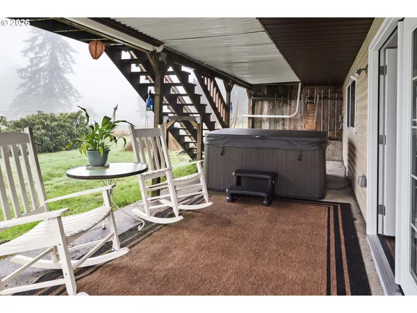 a view of an chairs and table in the balcony