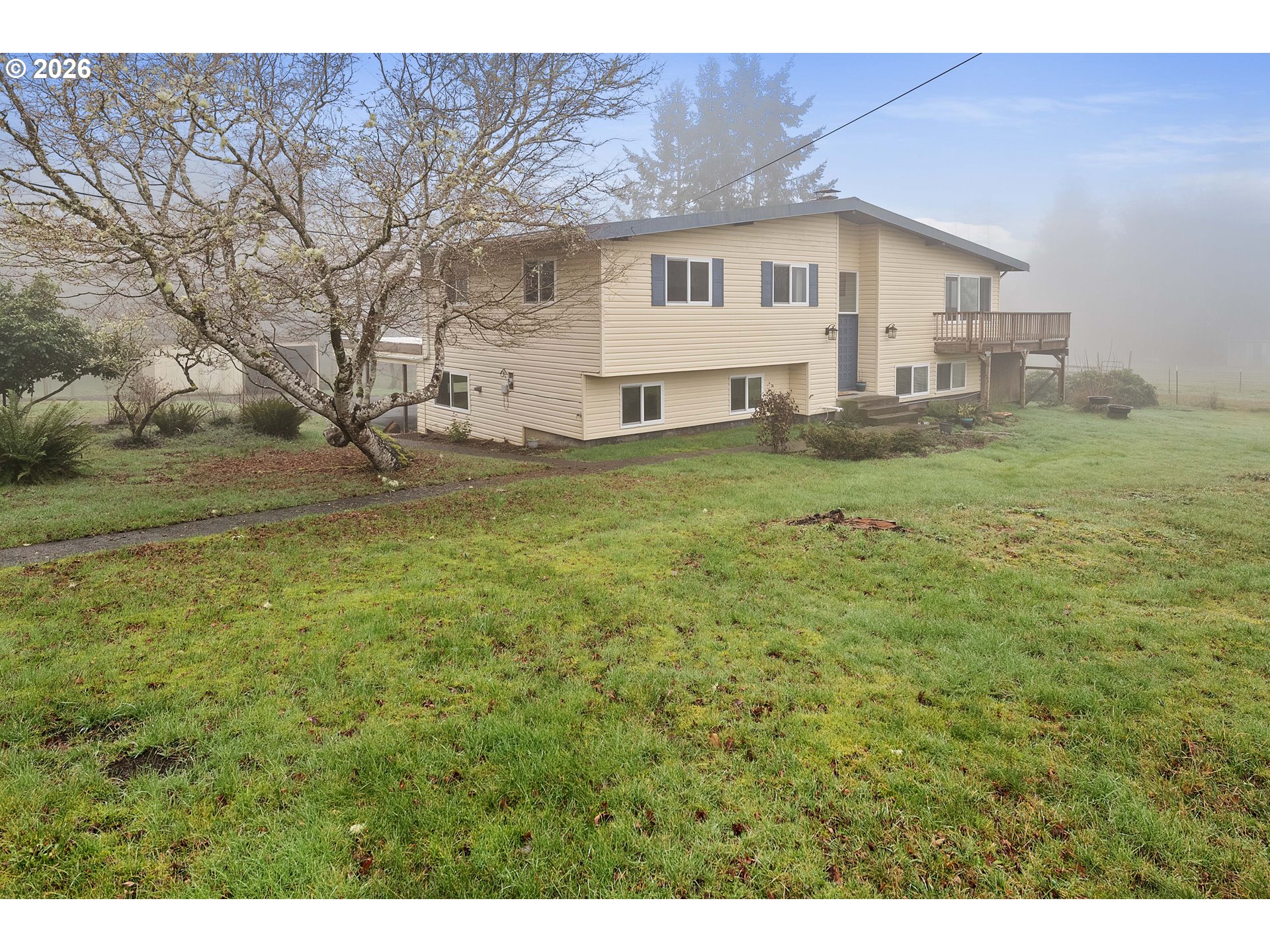 91614 George Hill Road Astoria, OR 97103 - Photo 34 of 44 a white house that has a big yard with wooden fence