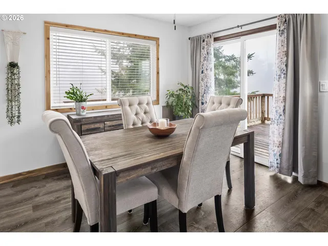 a dining room with furniture and wooden floor