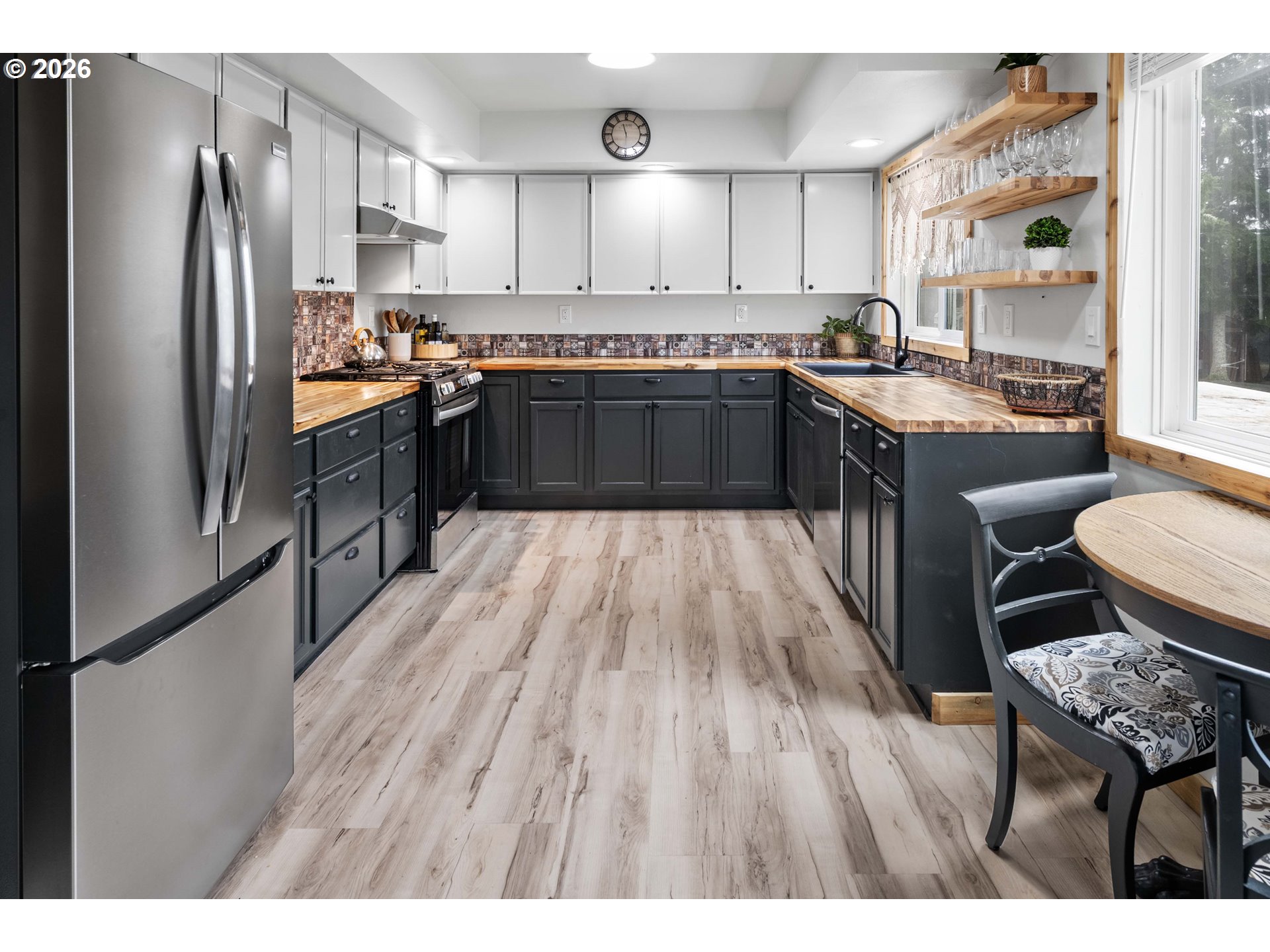 91614 George Hill Road Astoria, OR 97103 - Photo 8 of 44 a kitchen with stainless steel appliances granite countertop a refrigerator a sink dishwasher a stove with wooden cabinets and floor