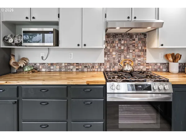 a stove top oven sitting inside of a kitchen
