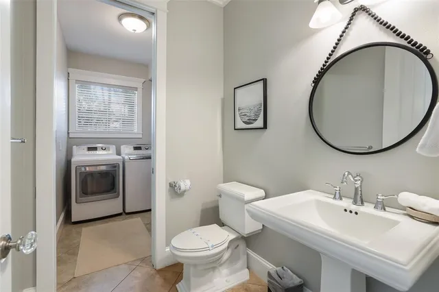a bathroom with a granite countertop sink a toilet and mirror