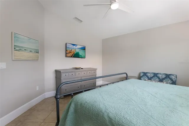 a view of a room with furniture and a ceiling fan