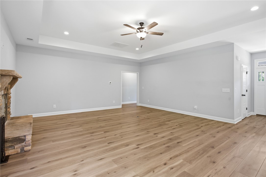 912 Watercrest Road West Union, SC 29696 - Photo 7 of 49 This living room features elegant wood flooring and a beautiful stone fireplace, perfect for relaxation.