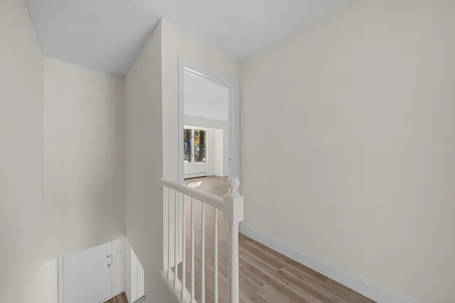 a view of a hallway with white walls