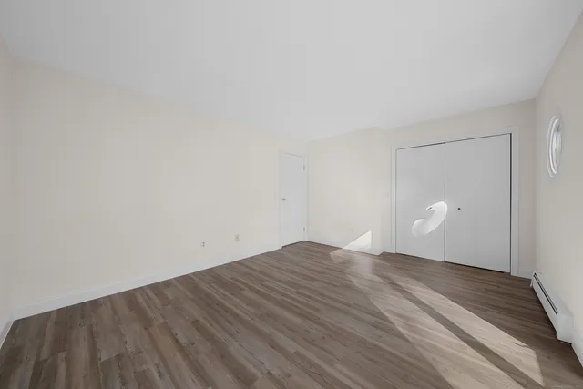 a view of room with wooden floor