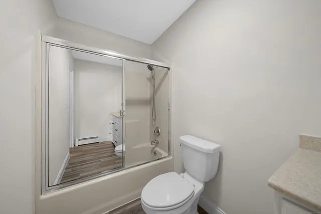 a bathroom with a toilet and a shower