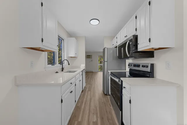 a kitchen with stainless steel appliances a sink stove and refrigerator