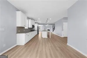 a view of kitchen with wooden floor