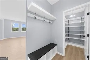 a view of walk in closet with empty racks