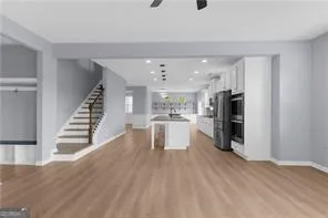 a view of kitchen with furniture and wooden floor