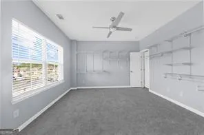 a view of a livingroom with a ceiling fan and window