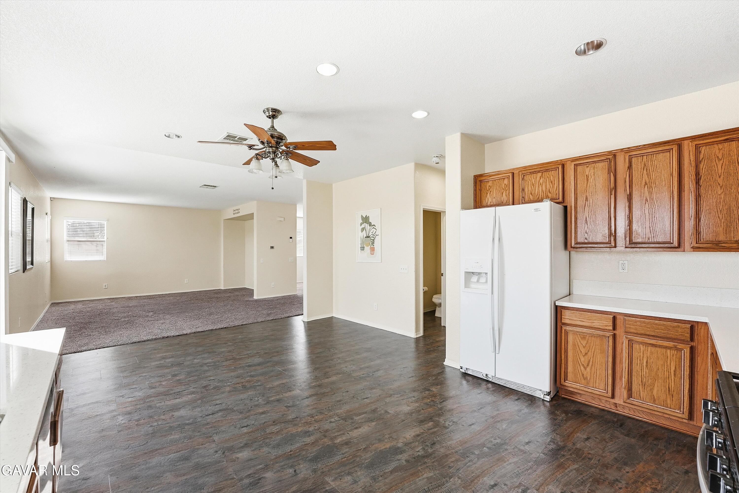 44232 Begonia Street Lancaster, CA 93535 - Photo 12 of 39 a view of a kitchen with a sink and a refrigerator