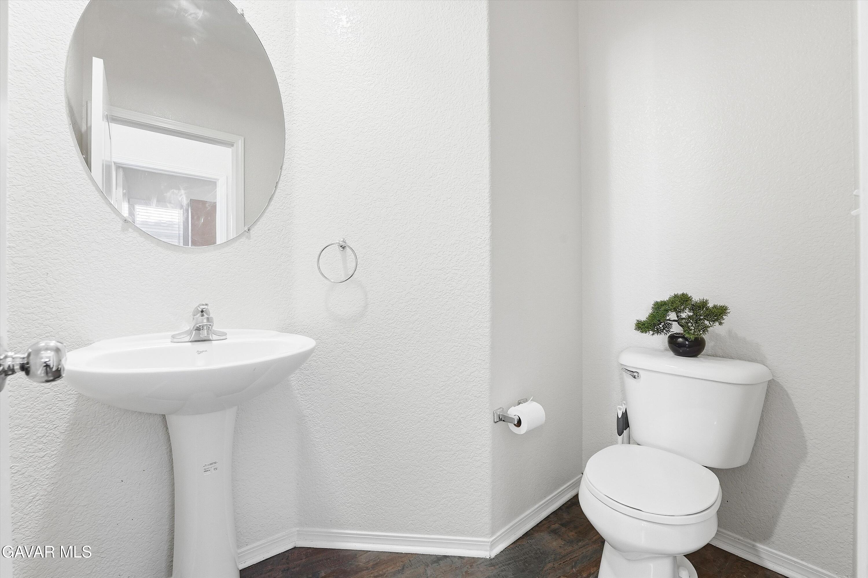 44232 Begonia Street Lancaster, CA 93535 - Photo 14 of 39 a bathroom with a toilet sink and mirror