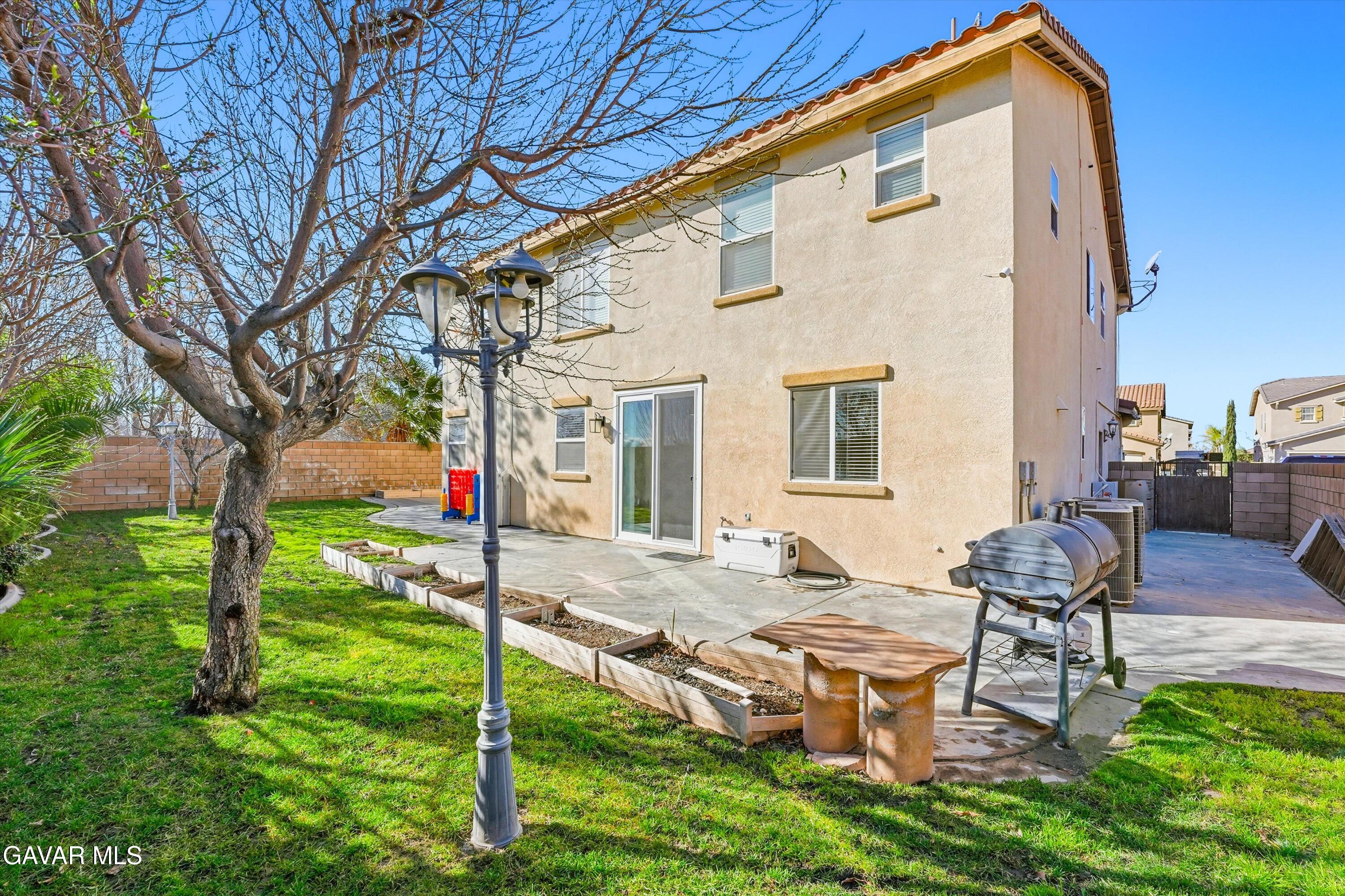 44232 Begonia Street Lancaster, CA 93535 - Photo 16 of 39 a backyard of a house with table and chairs