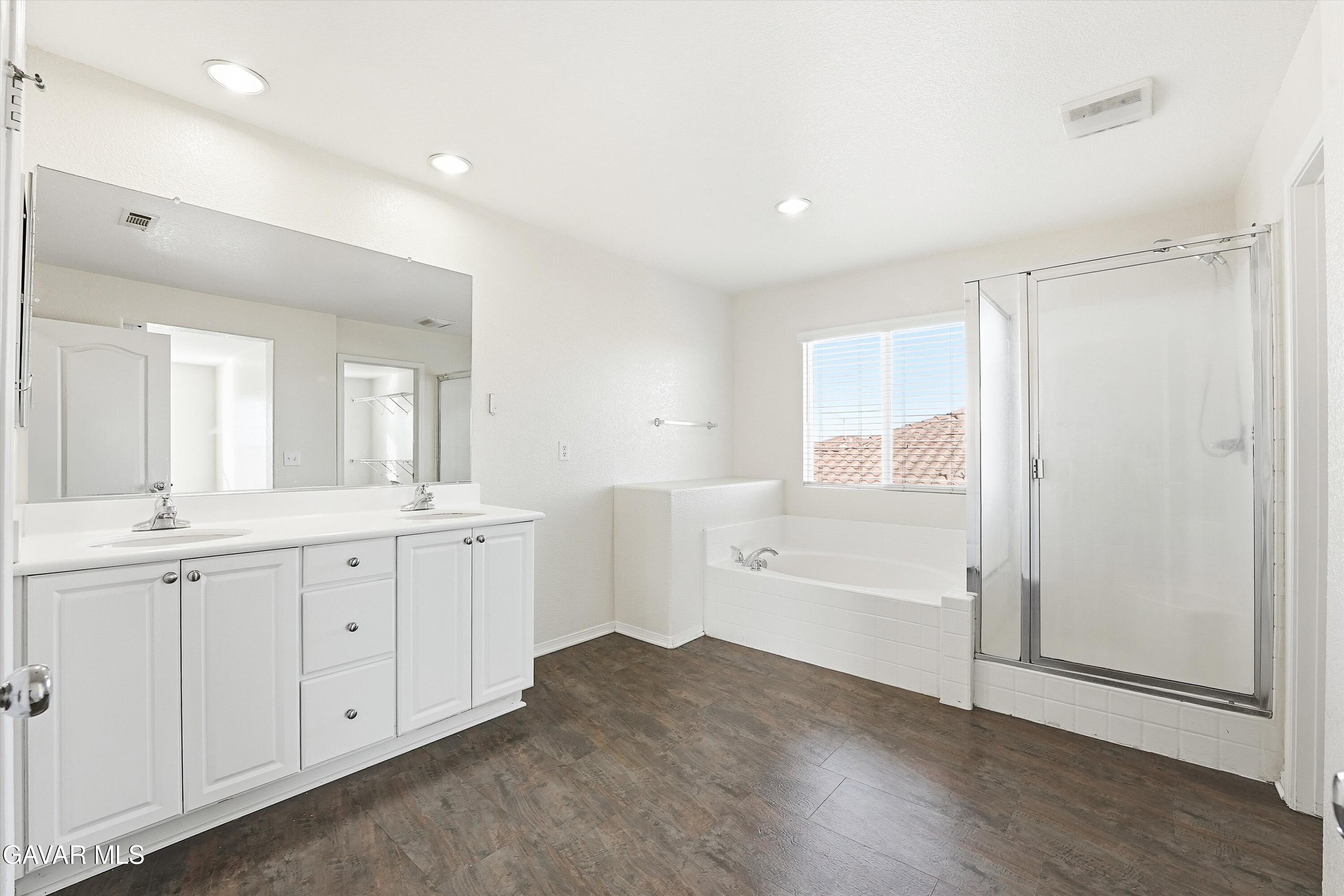 44232 Begonia Street Lancaster, CA 93535 - Photo 22 of 39 a spacious bathroom with a double vanity sink a mirror and a shower