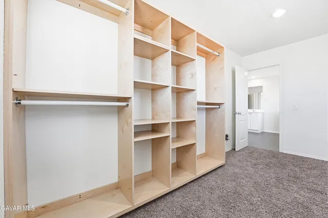 a bathroom with a granite countertop sink a toilet and a mirror