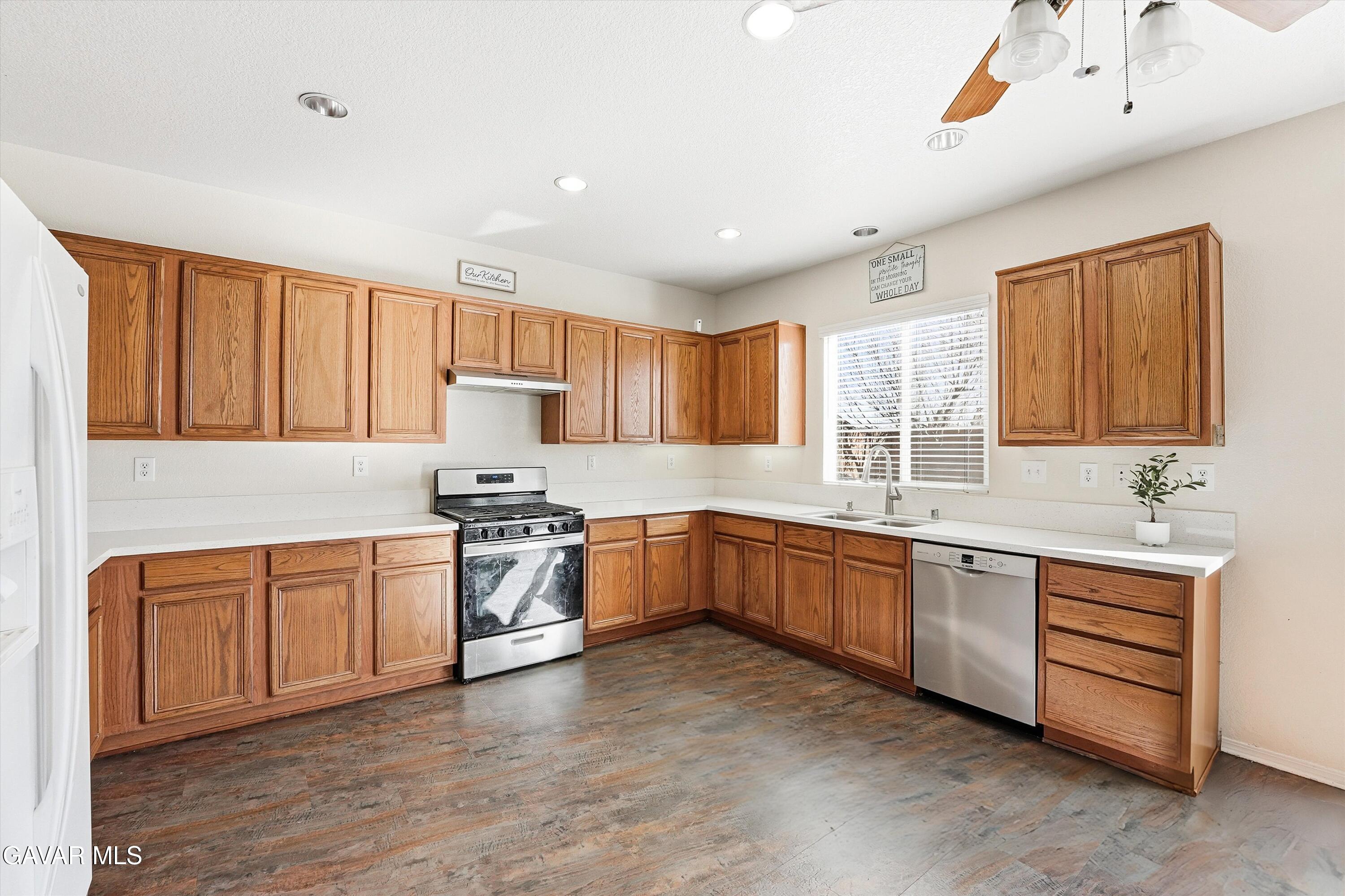 44232 Begonia Street Lancaster, CA 93535 - Photo 10 of 39 a kitchen with stainless steel appliances granite countertop a stove sink and cabinets