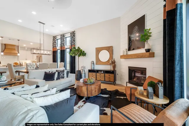a living room with furniture kitchen view and a fireplace